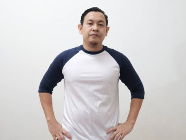 Asyalı bir adam beyaz arka planda hayal kırıklığına uğramış üzgün bir şekilde kameraya bakıyor.