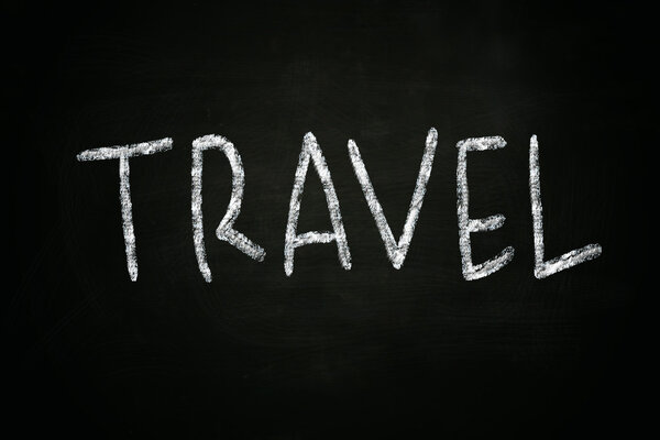 The word Travel written with chalk on blackboard