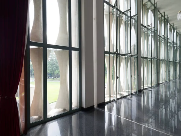 Geniş bir koridorda parlak pencereler.