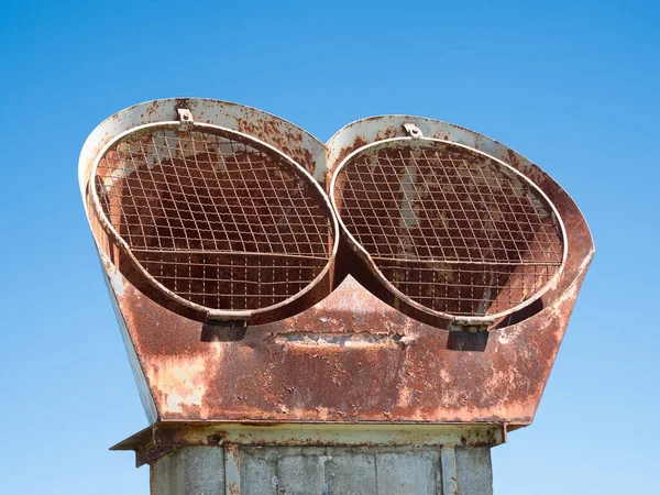 rusty structure in the shape of two eyes