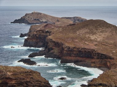 Madeira Deniz Yığını Üzerinde Altın Gün Batımı - Madeira 'daki Ilhus da Ribeira da Janela volkanik deniz yığınlarının gün batımında atmosferik manzarası, kayalık plaj ve Atlantik Okyanusu' nun üzerine düşen altın bir ışık.