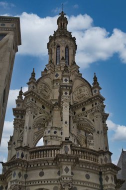 Chambord Normandiya Fransa 16 Temmuz 2025 'te Fransa' nın şatosu Chambord 'un Rönesans mimarisinin yakın çekimi. Karmaşık taş işçiliği ve karanlık çatı detayları mavi gökyüzüne karşı.