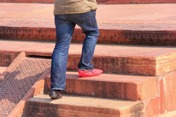 Close up of a man wearing one show cover, Tomb of Itimad-ud-Daul — Stock Photo, Image