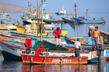 PARACAS, PERU-JANUARY 26: Unidentified men stand in a fishing bo clipart