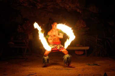 Fire show in famous Hina cave, blurred motion, Oholei beach, Ton clipart
