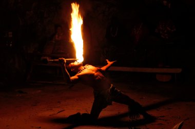 Fire show in famous Hina cave, blurred motion, Oholei beach, Ton clipart