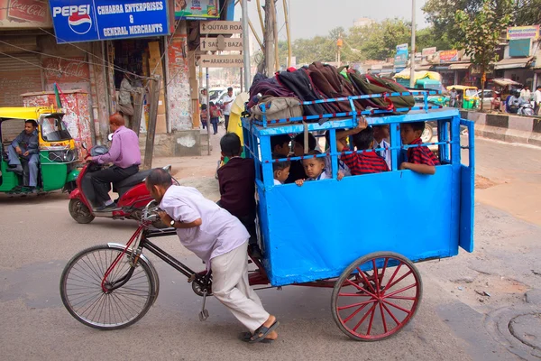 DELHI, INDIA - 5 NOVEMBRE: I bambini non identificati portano il risciò a scuola il 5 novembre 2014 a Delhi, India. Ciclo risciò sono una modalità di viaggio popolare per i transiti a breve distanza in città . — Foto Stock