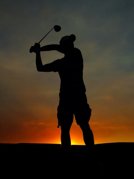 Silhouette of a golf player