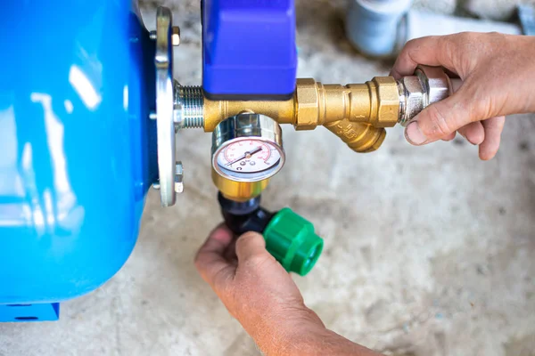 Installation of a water supply station to a residential building using a hydraulic accumulator. Pumping station. — Stock Image Installation Water Supply Station Residential Building Using Hydraulic Accumulator Pumping Royalty Free Stock Images
