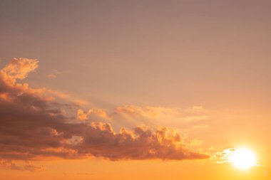 Bright sky with clouds. Yellow sunset on an autumn day. The beauty of nature, copy space
