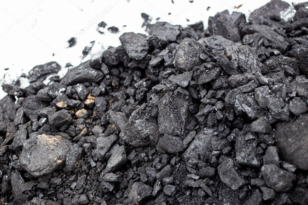 Coarse coal in the snow in winter. Maintaining high temperatures in fuel boilers, home heating systems. Combustible mineral.