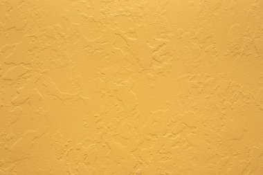 Duvarda benekli sarı alçı deseni var. Binanın onarımı ve dekorasyonu. Metin için yer.