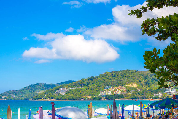 Sunny tropical resort in Thailand. Sea and mountains on Patong beach in Phuket. Travel and tourism.