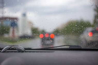 Trafik ışıkları ön camdan görülebiliyor, yağmurlu ve fırtınalı hava koşulları