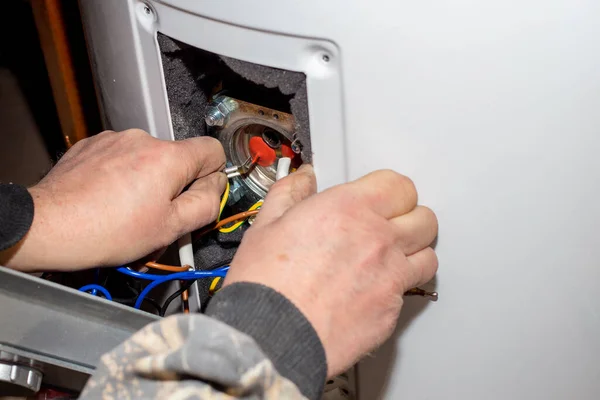 The foreman disassembled the electric boiler for repair and maintenance. Heater control relay.