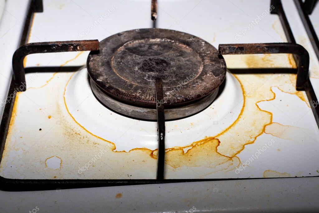 Dirty metal plate. The gas hob burner becomes covered with dirt and grease after cooking.