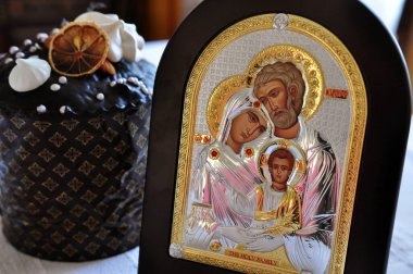 Hıristiyan Simgesi ve Paskalya çöreği masada.