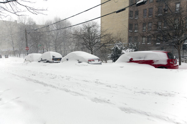 BRONX, NEW YORK - JANUARY 23: Blizzard storm Jonas curries cars in snow on Woodycrest avenue. Taken January 23, 2016, in the Bronx, New York.