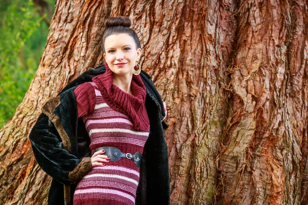 Fashionable young woman in park — Stock Photo, Image