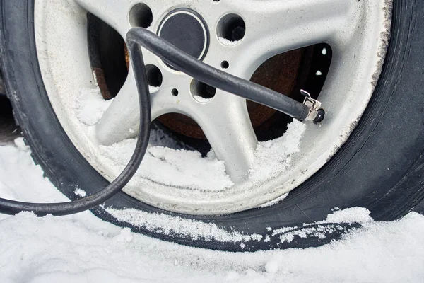flat rim. tire puncture. pump pumps air into the tire in winter.