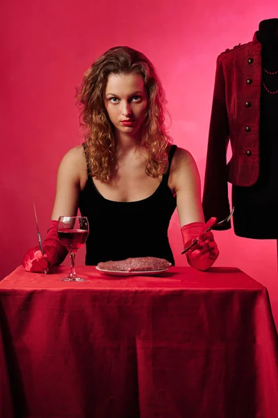 glamorous girl at the table to eat meat. fashion concept