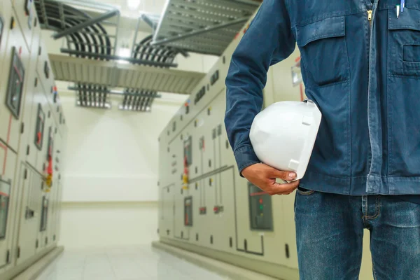 Helmet engineer in the rear panel switch electrical industry. — Stock Photo, Image