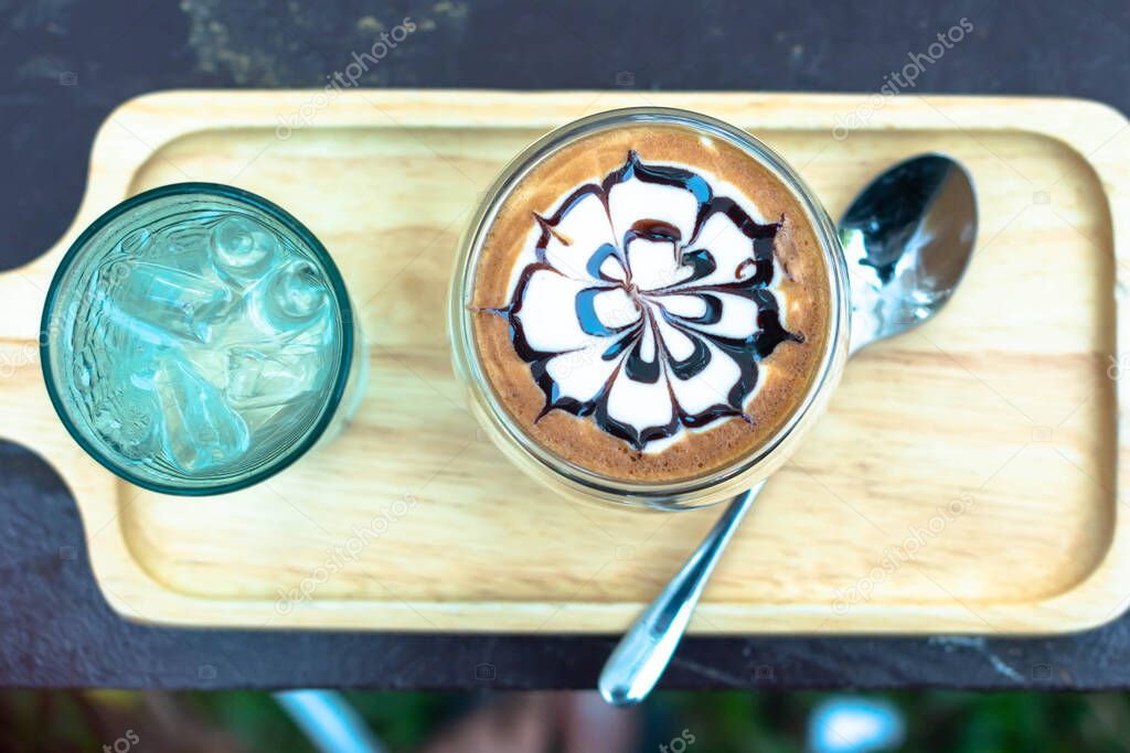 Cup of hot latte art cappuccino  Hot coffee cup on table, relax tim Fresh brewed coffees with beautiful latte art on surface.