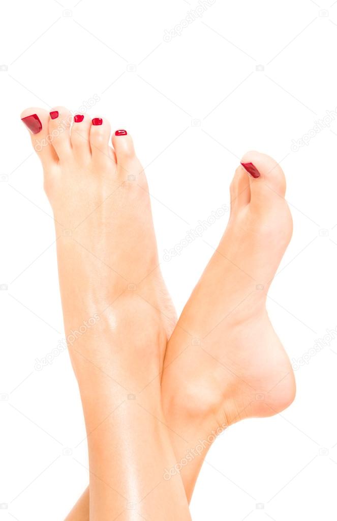 Beautiful female feet with red pedicure