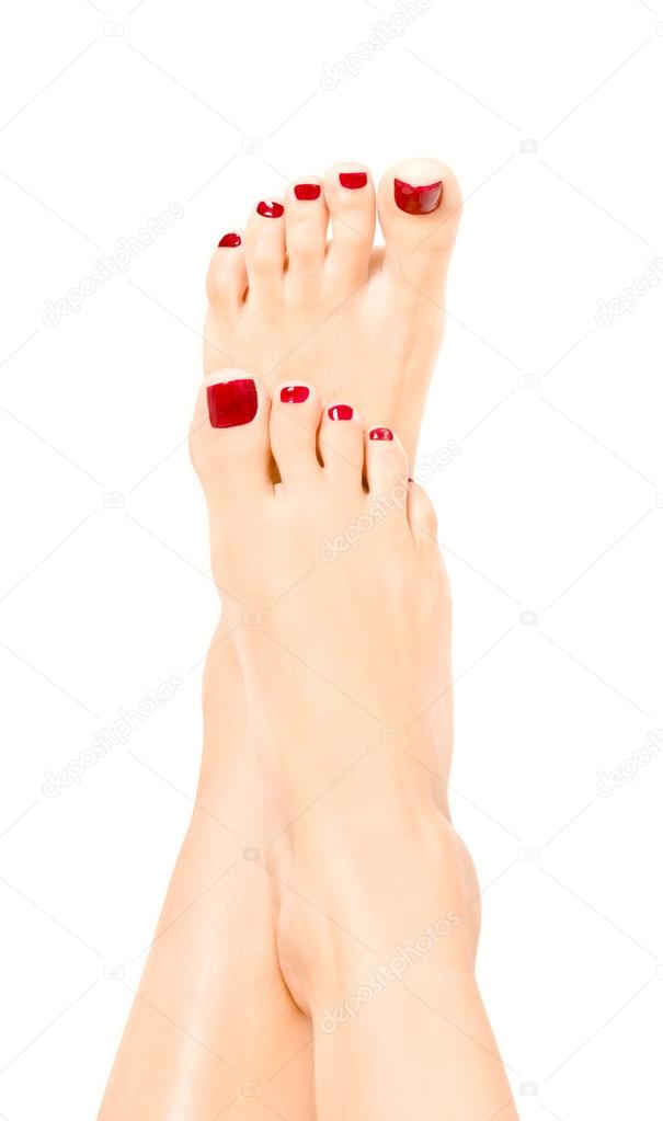 Beautiful well-groomed female feet with red pedicure