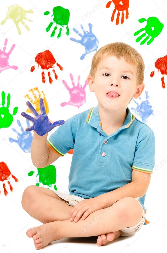 Cheerful boy sitting with hand painted