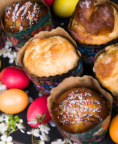 Påsk söta bröd med färgglada ägg och körsbär grenar — Stockfoto