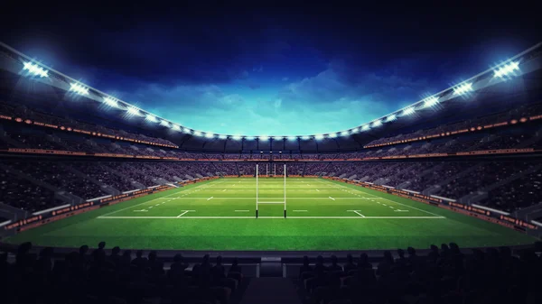 Stade de rugby illuminé avec spectateurs et herbe verte — Photo