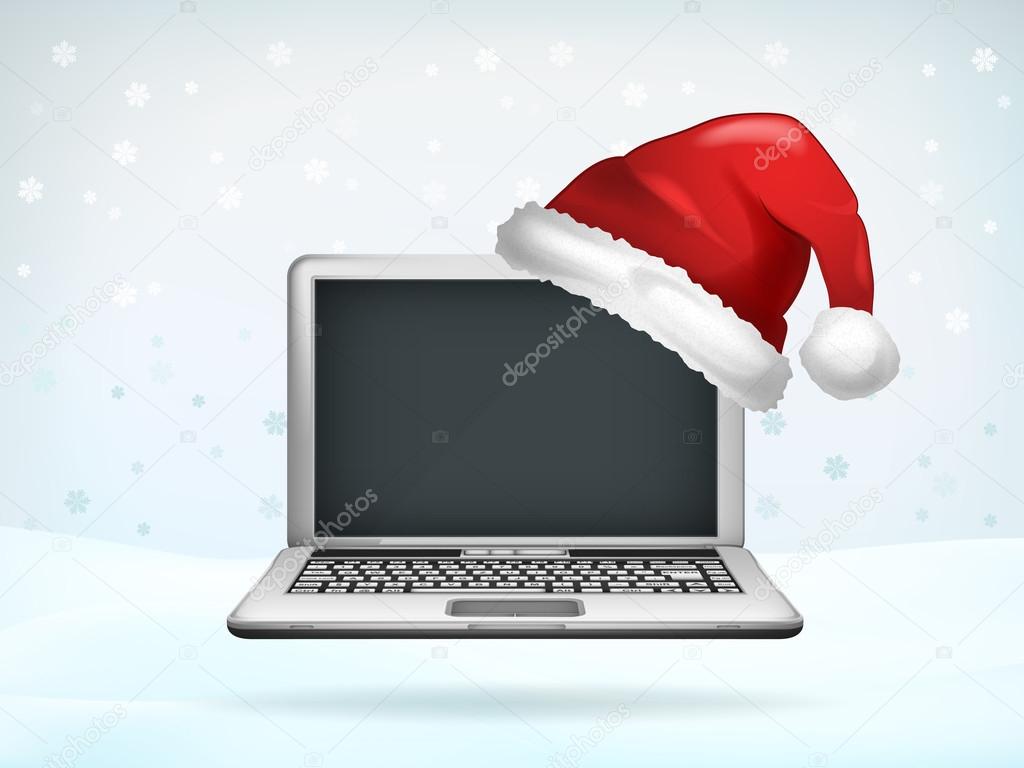 blank screen of laptop covered with Santa cap 