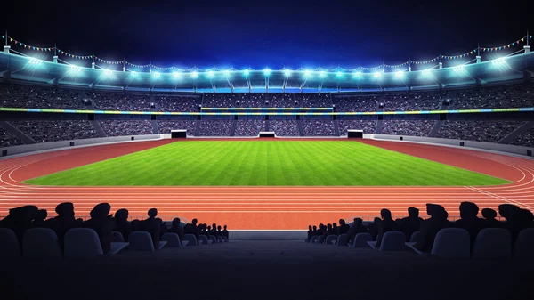 Stadio di atletica con pista e campo in erba vista notturna laterale — Foto Stock