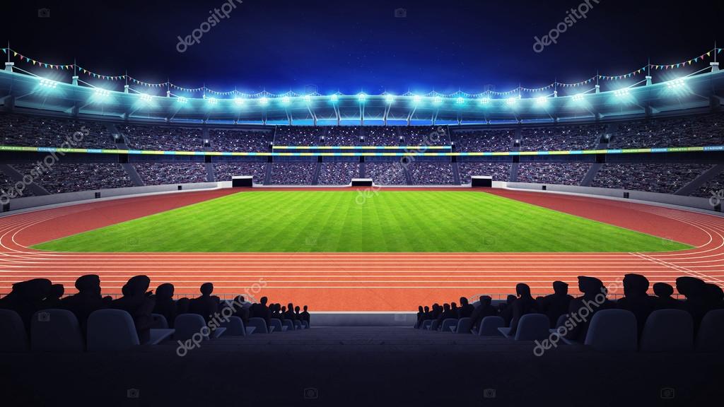 Athletics stadium with track and grass field at side night view — Stock