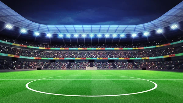 Освітлений футбольний стадіон з фанатами на трибунах — стокове фото