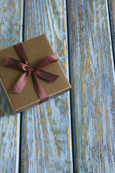 Giftbox on vintage wooden board — Stock Photo, Image