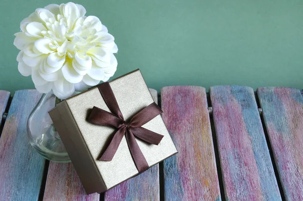 Gift box on vintage wooden board — Stock Photo, Image