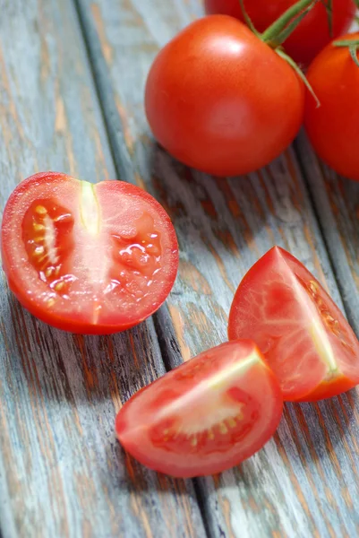 Tomatoes on rustic wooden background — Stock Photo, Image