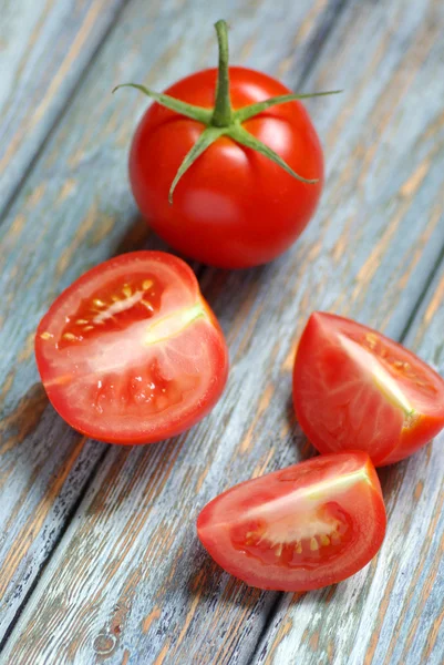 Tomatoes on rustic wooden background — Stock Photo, Image