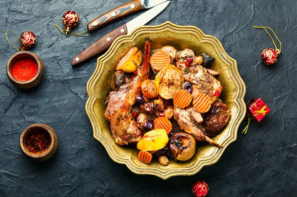 Braised rabbit meat with fruits.Baked meat for the Christmas table. Christmas dish.