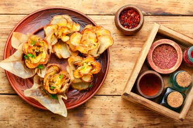 Ahşap masanın üzerinde domuz pastırmalı kızarmış patates.