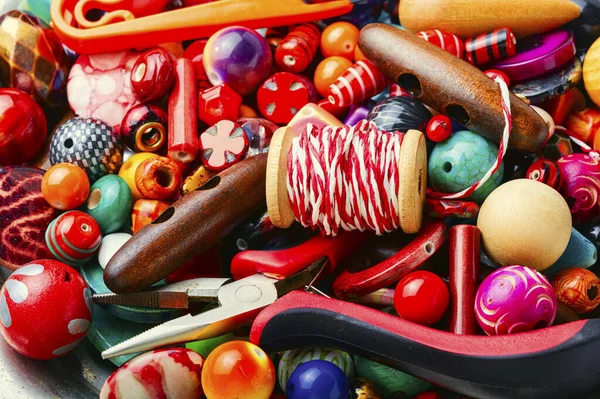 Bead with tools and accessories for making jewelry.Decorative colorful beads