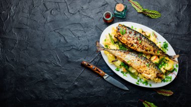 İştah açıcı kızarmış uskumru haşlanmış patates ve bitkilerle. Mesaj için yer var.