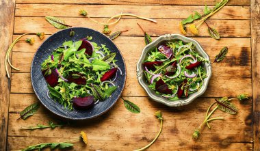 Fresh dandelion, sorrel and beetroot salad on rustic wooden table.Healthy eating,spring mix clipart