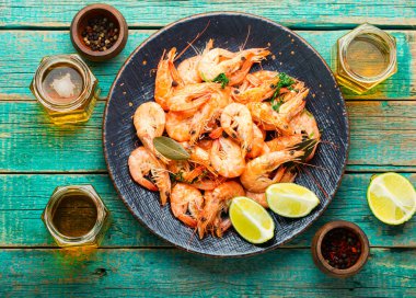 Boiled shrimp and fresh beer in jars.Fresh cooked prawn on wooden table.Seafood