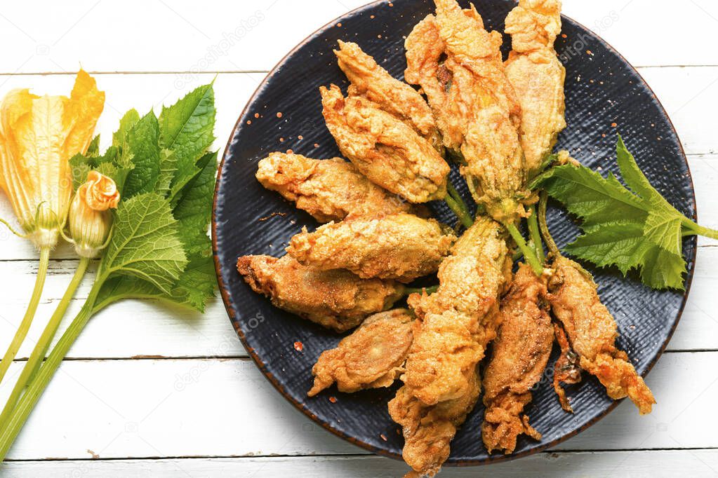 Fried zucchini flowers stuffed cottage cheese.Roasted courgette flowers.Healthy food,stuffed squash blossoms