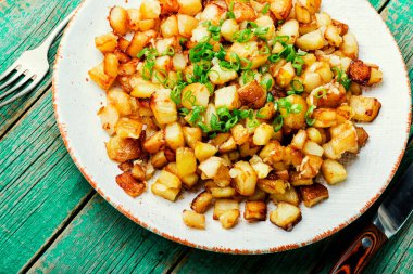 İştah açıcı kızarmış patatesler. Köy ahşap masada lezzetli fırında patatesler.