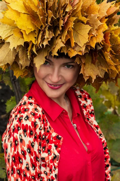 Menina com grinalda de folhas de bordo de outono — Fotografia de Stock
