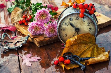 Old clock on the background of fallen leaves clipart